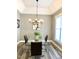 Elegant dining room with chandelier and glass dining table at 55 Running Deer Path, Timberlake, NC 27583