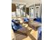 Spacious screened porch with wicker furniture and a hot tub at 55 Running Deer Path, Timberlake, NC 27583