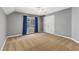 Spacious bedroom with gray walls and blue curtains at 7212 Mira Mar Pl, Wake Forest, NC 27587