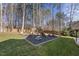 Playset in backyard with wood chips and lawn at 803 Clausun Dr, Durham, NC 27713