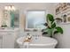 Bathroom with a large soaking tub, double vanity, and a window at 8101 Fergus Ct, Wake Forest, NC 27587