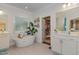 Spa-like bathroom featuring a free-standing tub and walk-in closet at 8101 Fergus Ct, Wake Forest, NC 27587