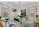 Cozy bedroom with a green velvet bed and plenty of natural light at 8101 Fergus Ct, Wake Forest, NC 27587