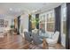 Modern breakfast nook with glass table and gray chairs near a fireplace at 8101 Fergus Ct, Wake Forest, NC 27587