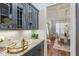 Elegant butler's pantry with granite countertops and dark cabinetry at 8101 Fergus Ct, Wake Forest, NC 27587