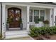 Elegant front entry with double doors and lush landscaping at 8101 Fergus Ct, Wake Forest, NC 27587