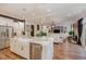 Open concept kitchen with a large island, white cabinets, and a farmhouse sink at 8101 Fergus Ct, Wake Forest, NC 27587