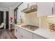 Kitchen features gas cooktop, white cabinets, and gold-toned hardware at 8101 Fergus Ct, Wake Forest, NC 27587
