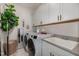 Laundry room with white cabinets, washer, dryer and a utility sink at 8101 Fergus Ct, Wake Forest, NC 27587