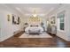 Spacious main bedroom with hardwood floors and a cozy sitting area at 8101 Fergus Ct, Wake Forest, NC 27587