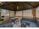 Relaxing covered patio with seating and outdoor lighting at 8101 Fergus Ct, Wake Forest, NC 27587