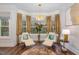 Relaxing sitting area with two armchairs and a large window at 8101 Fergus Ct, Wake Forest, NC 27587