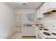 Efficient kitchen featuring white cabinets and an electric stove at 830 E Lenoir St, Raleigh, NC 27601
