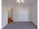 Well-lit bedroom with double closets and carpeting at 1004 Cabin Hill Way, Garner, NC 27529