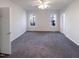 Empty bedroom with grey carpet and large windows at 1004 Cabin Hill Way, Garner, NC 27529