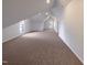 Large bonus room featuring vaulted ceiling, carpet, and multiple windows at 1004 Cabin Hill Way, Garner, NC 27529