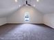 Spacious bonus room with vaulted ceiling, carpet, and large window at 1004 Cabin Hill Way, Garner, NC 27529