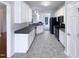 Modern kitchen with white cabinets and dark countertops at 1004 Cabin Hill Way, Garner, NC 27529