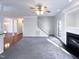 Spacious living room featuring hardwood floors, fireplace, and view into dining area at 1004 Cabin Hill Way, Garner, NC 27529