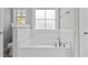 Relaxing bathroom featuring a soaking tub, tile surround, and modern fixtures at 104 Spruce Hollow Cir, Spring Lake, NC 28390
