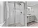 Modern bathroom with a walk-in shower, gray vanity, and stylish mirror at 104 Spruce Hollow Cir, Spring Lake, NC 28390