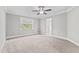 Bedroom with ceiling fan, carpet flooring, and access to a bathroom at 104 Spruce Hollow Cir, Spring Lake, NC 28390