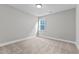 Well-lit bedroom with neutral walls, carpet flooring, and a window at 104 Spruce Hollow Cir, Spring Lake, NC 28390