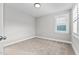 Spacious bedroom with neutral walls, carpet flooring, and a window with shutters at 104 Spruce Hollow Cir, Spring Lake, NC 28390