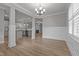 Open concept dining room with kitchen view and hardwood floors at 104 Spruce Hollow Cir, Spring Lake, NC 28390