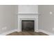 Modern corner fireplace with white mantel and mosaic tile surround at 104 Spruce Hollow Cir, Spring Lake, NC 28390