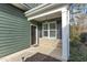 Inviting front porch with stone accents and a black door at 104 Spruce Hollow Cir, Spring Lake, NC 28390