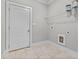 Laundry room with shelving, built-in cabinets, and tile flooring at 104 Spruce Hollow Cir, Spring Lake, NC 28390
