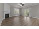 Living room with fireplace, hardwood floors, and access to backyard at 104 Spruce Hollow Cir, Spring Lake, NC 28390