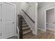 Modern staircase with dark wood railings and carpeted steps at 104 Spruce Hollow Cir, Spring Lake, NC 28390