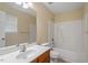 Neutral bathroom featuring a white vanity with a large mirror and a shower-tub combo at 11215 Lofty Heights Pl, Raleigh, NC 27614
