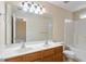 Bathroom featuring double sink vanity, large mirror, and shower-tub combo at 11215 Lofty Heights Pl, Raleigh, NC 27614