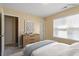 Cozy bedroom with natural light from the window and a stylish wooden dresser at 11215 Lofty Heights Pl, Raleigh, NC 27614