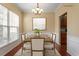 Elegant dining room showcasing wainscoting, wood floors, and a stylish chandelier at 11215 Lofty Heights Pl, Raleigh, NC 27614
