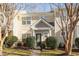 Tan siding two-story townhome with landscaping and walkway at 11215 Lofty Heights Pl, Raleigh, NC 27614
