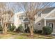 Two story townhome with tan siding and landscaping at 11215 Lofty Heights Pl, Raleigh, NC 27614