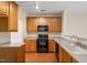 Well-equipped kitchen features wood cabinetry, granite countertops, and modern appliances at 11215 Lofty Heights Pl, Raleigh, NC 27614