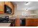 Open concept kitchen with stainless steel appliances and eat-in bar seating at 11215 Lofty Heights Pl, Raleigh, NC 27614