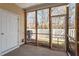 Cozy screened porch featuring a white fence and a view of the wooded backyard at 11215 Lofty Heights Pl, Raleigh, NC 27614