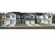 Front view of charming townhouses with attached garages and well-manicured lawns at 128 Parker Ln, Mebane, NC 27302