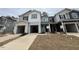 Charming townhomes featuring attached garages and modern architectural details at 128 Parker Ln, Mebane, NC 27302
