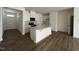 Bright open-concept kitchen featuring a central island and white cabinetry at 128 Parker Ln, Mebane, NC 27302