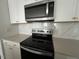 Stainless steel oven and microwave complemented by white shaker-style cabinetry at 128 Parker Ln, Mebane, NC 27302