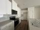 Bright kitchen features stainless appliances, modern white cabinetry and a stone countertop at 128 Parker Ln, Mebane, NC 27302