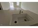 Close-up of a modern kitchen sink featuring stone countertops and an open-concept space at 128 Parker Ln, Mebane, NC 27302