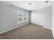 Well-lit bedroom with window blinds and neutral carpeting at 1611 Copper Cir, Mebane, NC 27302